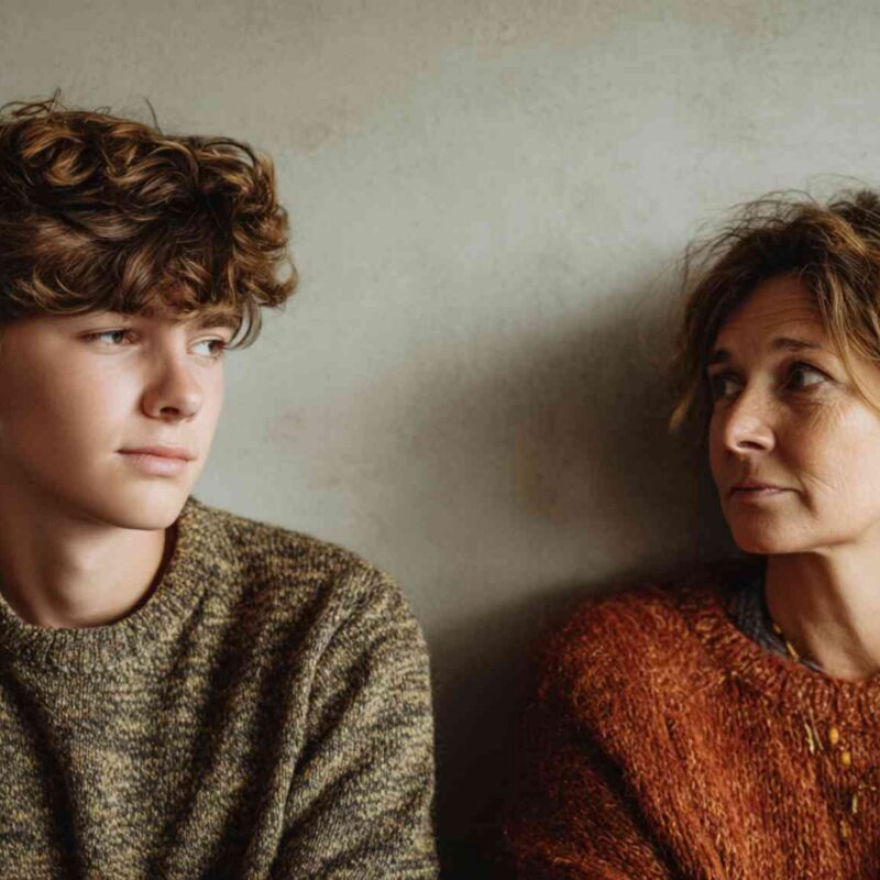 Does my teen need therapy — parent and teenage son sitting together during a quiet, thoughtful moment at home