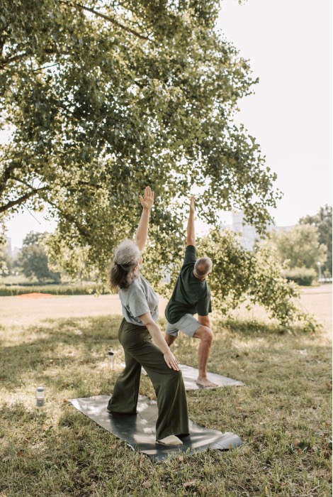 People practicing yoga outdoors as a gentle way to regulate your nervous system and improve resilience.
