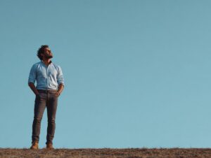 adhd-counseling-for-adults-man.jpg Man standing outdoors beneath a blue sky, accompanying an article about ADHD counseling for adults.
